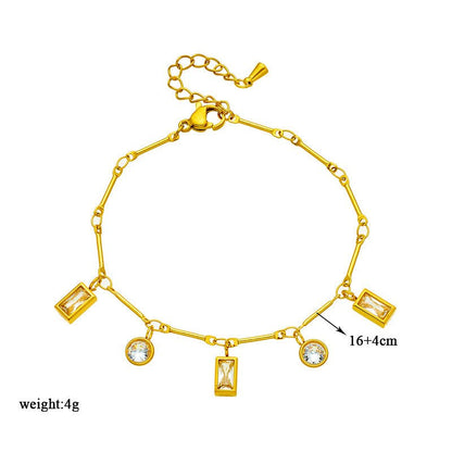 Gold bracelet with various charms on a white background