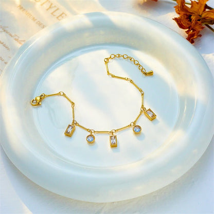Gold bracelet with gemstones on a white dish