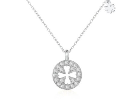 Silver necklace with a clover-shaped pendant on a white background