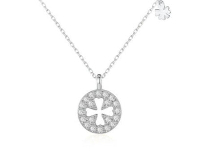 Silver necklace with a clover-shaped pendant on a white background