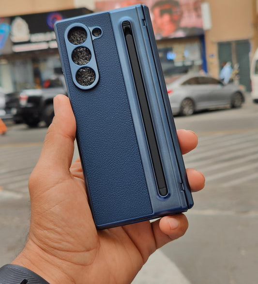 Blue phone case held in a hand with a city street background