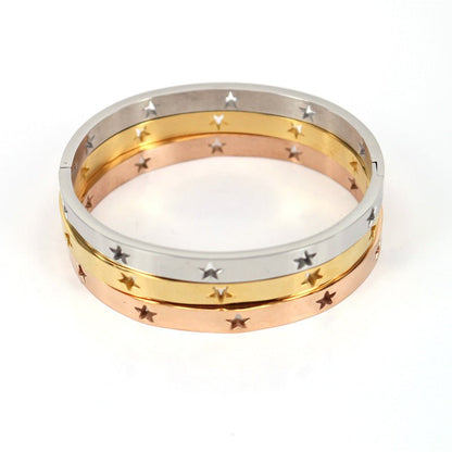 Three gold rings stacked on a white background