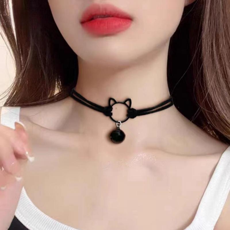 Black choker necklace with cat design worn by a person