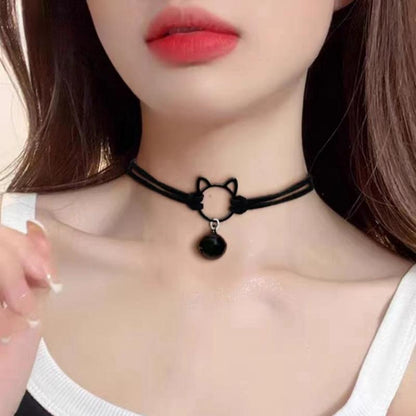 Black choker necklace with cat design worn by a person