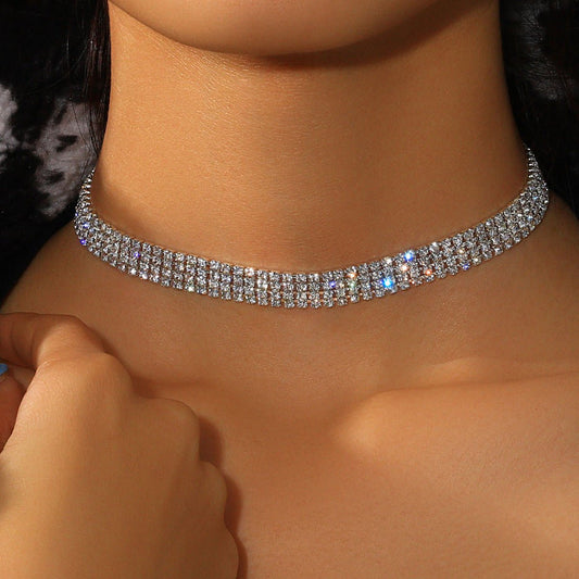 Close-up of a person wearing a sparkling choker necklace.