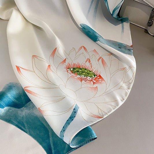Silk scarf with lotus flower design on a neutral background
