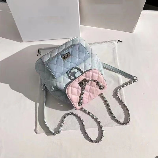 Two quilted handbags, one light blue and one pink, with a chain strap on a white background.