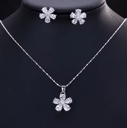 Silver necklace with a flower pendant on a black mannequin