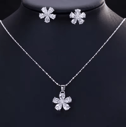 Silver necklace with a flower pendant on a black mannequin